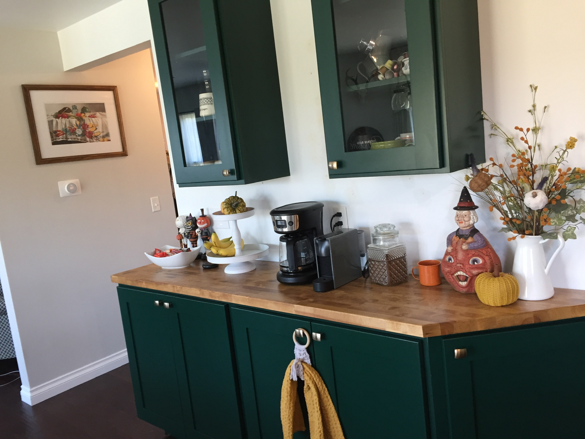 Dark green kitchen cabinets and butcher-block counter