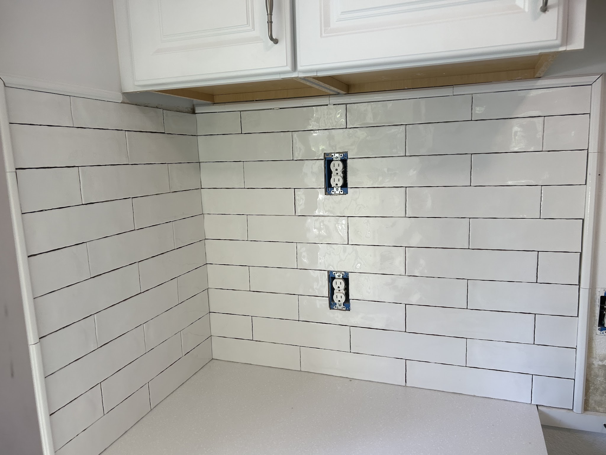 White subway-tile kitchen backsplash